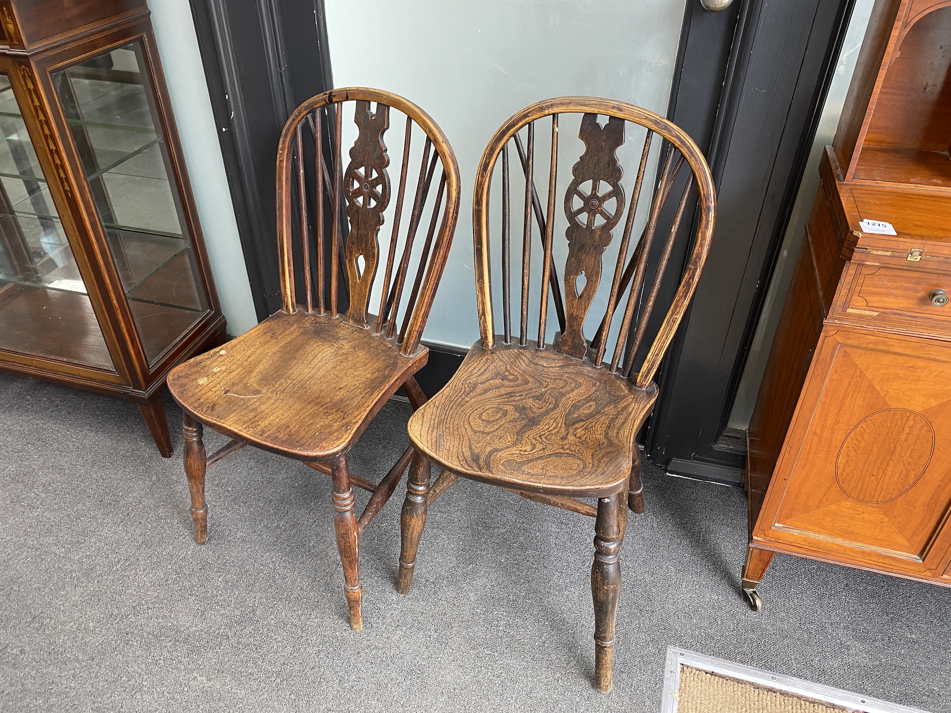 A harlequin set of ten 19th century ash and elm Windsor wheelback dining chairs, two with arms